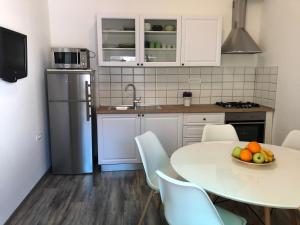 a kitchen with a table with a bowl of fruit on it at Apartment Check in in Pula