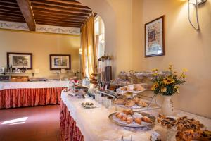 a buffet table with bread and pastries on it at Villa Borgo San Pietro in Cortona