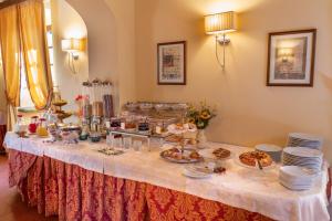 a table with a buffet of food on it at Villa Borgo San Pietro in Cortona
