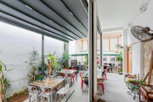 a patio with tables and chairs and windows at TasEV Guesthouse in Lefkosa Turk