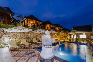 a villa with a swimming pool and a house at Sunday Huts Lembongan in Nusa Lembongan