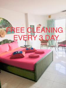 a bed with a red sign that reads free cleaning every days at View Talay 1B Apartments in Pattaya South