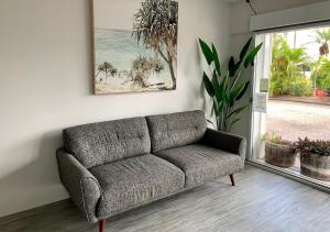a living room with a couch and a table at Outrigger Burleigh in Gold Coast
