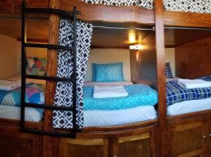 a couple of bunk beds in a room at De Alamo hostel in Rosarito