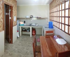 a small kitchen with a table and a counter at Mountain View Cottages in Mambajao