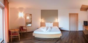 Postel nebo postele na pokoji v ubytování Garni Hotel Peterlinhof