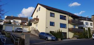 a house with a car parked in front of it at Ferienwohnung Angelika in Bad Kissingen