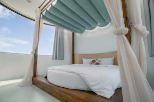 a bedroom with a canopy bed and a window at Love Tour in Magong