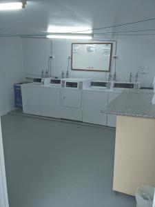 a laboratory with white appliances in a room at Arkana Motel in Maryborough
