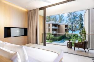 カマラビーチにあるTwinpalms MontAzure Phuketのベッドルーム(大型ベッド1台、大きな窓付)