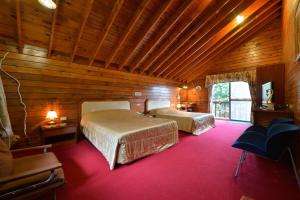 Postel nebo postele na pokoji v ubytování Shinmingshan Holiday Inn