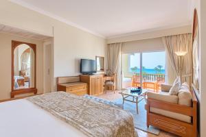 a hotel room with a bed and a view of the ocean at Kempinski Hotel Soma Bay in Hurghada