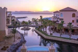 an aerial view of a resort with a river at Kempinski Hotel Soma Bay in Hurghada