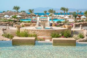 a resort with a fountain and a swimming pool at Kempinski Hotel Soma Bay in Hurghada