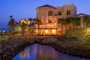 a hotel with a river in front of a building at Kempinski Hotel Soma Bay in Hurghada