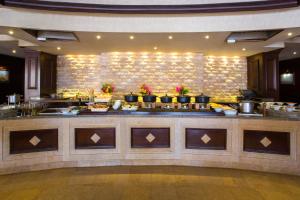 a buffet line in a restaurant with food on display at Kempinski Hotel Soma Bay in Hurghada