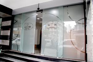 a store window with two signs that say my hotel at Sleep Inn Hotel - Kariakoo in Dar es Salaam