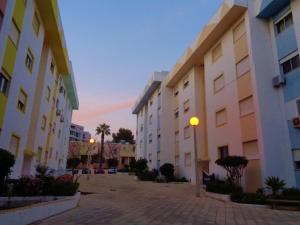 a group of buildings in a courtyard with palm trees at Apartment Poeta Aleixo in Faro in Faro