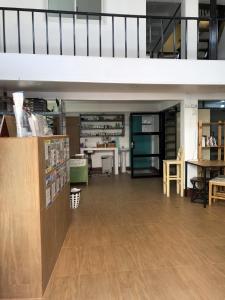 a large room with tables and chairs in a building at PLOY Hostel in Bangkok