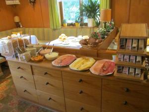 a kitchen filled with lots of different types of food at Hotel Carossa bed&breakfast in Sankt Gilgen