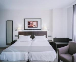 Tempat tidur dalam kamar di Hotel Cristina