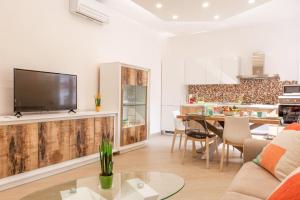 a living room with a couch and a table at Appartamento Sorrento Sunrise in Sorrento