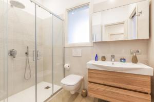 a bathroom with a toilet and a sink and a shower at Appartamento Sorrento Sunrise in Sorrento +21 photos