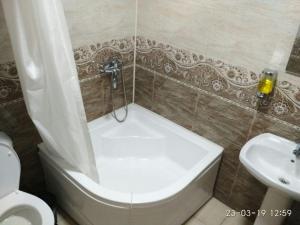 a bathroom with a tub and a toilet and a sink at Mubina Khiva B&B in Khiva +76 photos