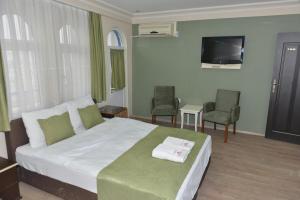 Кровать или кровати в номере Teras Hotel Kağıthane