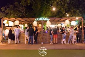 a group of people standing around a bar at night at Beach Apartment Marina Vilamoura in Vilamoura +179 photos