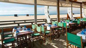 a restaurant on the beach with tables and chairs at Beach Apartment Marina Vilamoura in Vilamoura