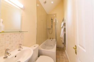 a bathroom with a sink and a toilet and a shower at Riding Farm Cottages in Gateshead