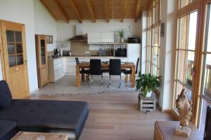 a kitchen and dining room with a table and chairs at Ferienwohnung Panoramablick in Marquartstein