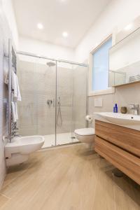 a bathroom with a shower and a sink and a toilet at Appartamento Sorrento Sunrise in Sorrento