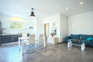 ein Wohnzimmer mit einem Tisch und einem blauen Sofa in der Unterkunft *Amazing modern apartment with 2 bedrooms* in Vodnjan