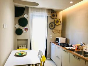 a kitchen with a table with a cake on it at MaSà Appartamenti (Il Mare in Salotto) in Pescara