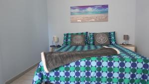 a bedroom with a bed with green and blue at Corte Risco in Ogliastro Cilento