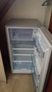 an empty refrigerator with its door open in a room at Gallipoli centro in Gallipoli