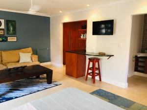 a living room with a couch and a table at Cottage Kilkenny in Johannesburg