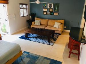 a living room with a couch and a coffee table at Cottage Kilkenny in Johannesburg