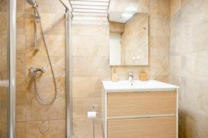 a bathroom with a shower and a sink at Loft 1º de Maio in Tavira +12 photos