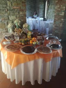 a table with a buffet of food on it at Castello di Trisobbio in Trisobbio