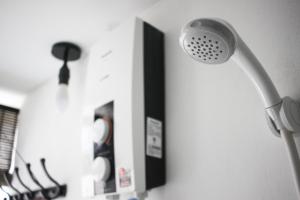 a shower head on a wall in a bathroom at TEMPO in Semporna