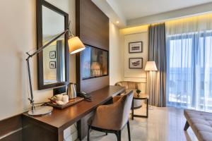 a room with a desk in a hotel room at Hotel California by Aycon in Sveti Stefan