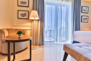 a living room with a couch and a table at Hotel California by Aycon in Sveti Stefan