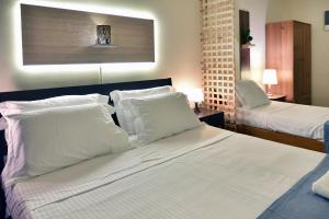 Posteľ alebo postele v izbe v ubytovaní Nikolas Rooms