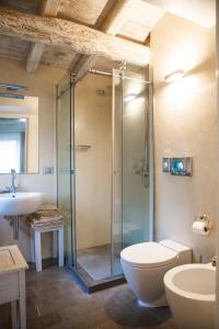 a bathroom with a shower and a toilet and a sink at Misia Resort in Orvieto