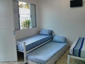 A bed or beds in a room at POUSADA TANI COM AR E PISCINA em MARESIAS