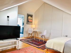 a bedroom with a flat screen tv and a bed at Camden Town House in London