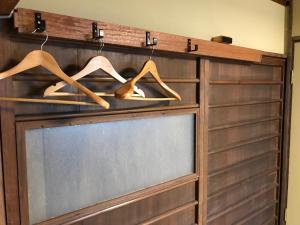 a sliding barn door window with wooden hangers at Guesthouse Naramachi in Nara